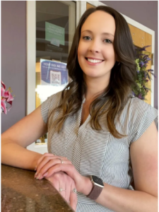 team member smiling at front desk